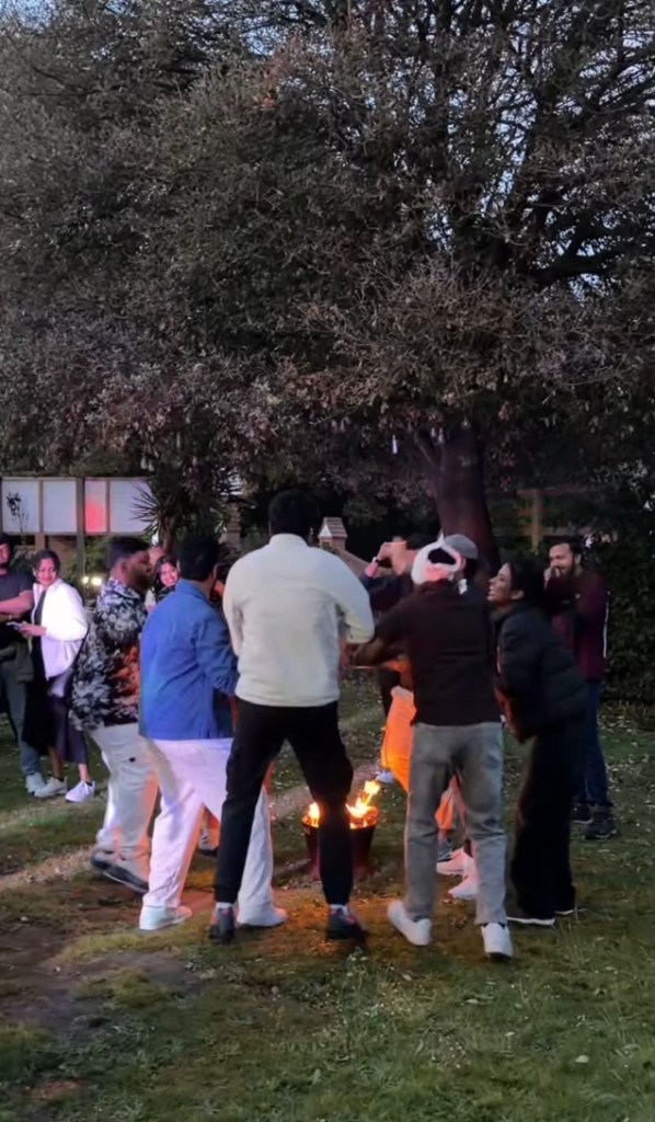 Guests gathering around a fire pit in the hotel garden